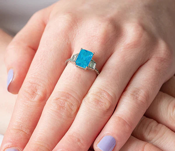 Diamond Style London - Aquamarine coloured ring in rhodium plating with c (Item code: Aquaring6)